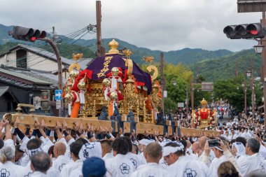Arashiyama, Kyoto, Japan - May 25, 2025 : Saga Matsuri Kanko-sai festival Nonomiya Shrine mikoshi, a sacred purple portable shrine paraded through the streets.