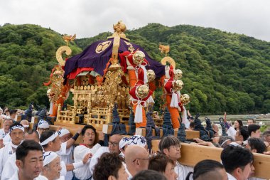 Arashiyama, Kyoto, Japan - May 25, 2025 : Saga Matsuri Kanko-sai festival Nonomiya Shrine mikoshi, a sacred purple portable shrine paraded through the streets.