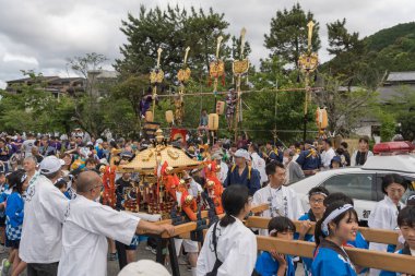 Arashiyama, Kyoto, Japan - May 25, 2025 : Saga Matsuri Kanko-sai festival local children parading through town while carrying the Kodomo Mikoshi, a smaller portable shrine for the youth.