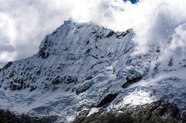 Savage snow covered mountains in the Cordeleira Blanca region of the high Andes in Peru. clipart