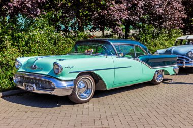 1957 Oldsmobile Starfire 98 Holiday Coupe vintage car. Den Bosch, The Netherlands - May 8, 2016 clipart
