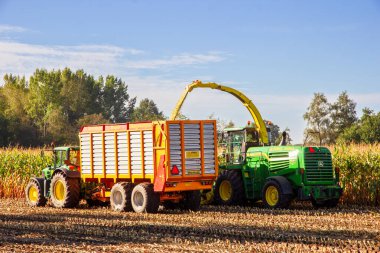  John Deere 6930 tractor and John Deere 7480i Forage Harvester at work. Achterhoek, Netherlands - Sep 19, 2016 clipart