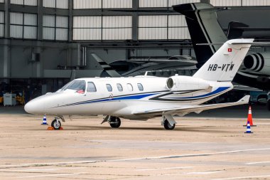 Cessna 525 Citation M2 private jet in front of a hangar at Le Bourget Airport. Paris, France - June 22, 2023 clipart