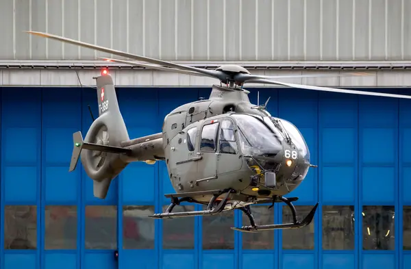 stock image Swiss Air Force Eurocopter EC635 helicopter taking of from Alpnach airfield. Alpnach, Switzerland - February 27, 2024