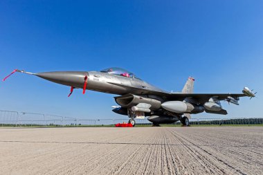 US Air Force F-16C fighter jet from Spangdahlem Air Base on the tarmac of Schonefled Airport. Berlin, Germany - May 22, 2014 clipart