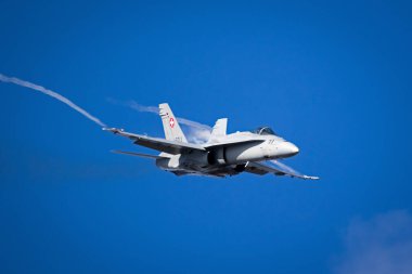 Swiss Air Force McDonnell Douglas FA-18 Hornet fighter jet plane in flight above Kleine-Brogel Airbase. September 8, 2018 clipart