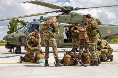 Belgian army soldiers preparing for the THPU exercise. THPU is an annual helicopter evaluation excercise. Beauvechain Air base, Belgium - May 20, 2015 clipart