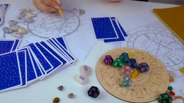 Woman astrologer draws a natal chart. Selective focus. People.