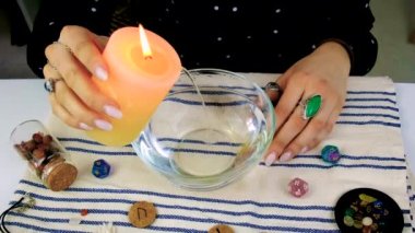 Woman fortune teller fortune telling wax candles. Selective focus. people.