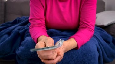 The old woman gives dollars. selective focus. People.