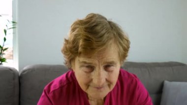 An old woman puts on glasses. selective focus. People.