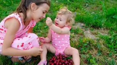 Çocuk bahçede kiraz yiyor. Seçici odaklanma. Çocuk.