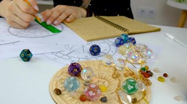 Woman astrologer draws a natal chart. Selective focus. People.