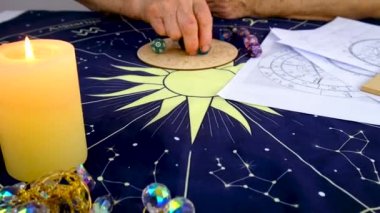 Woman astrologer draws a natal chart. Selective focus. People.