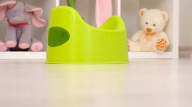 The child sits on the potty. Selective focus. Kid.