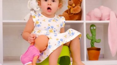 The child sits on the potty. Selective focus. Kid.