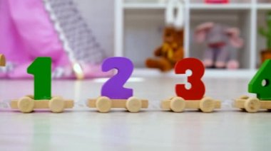 A child plays with a train made of numbers. Selective focus. Kid.