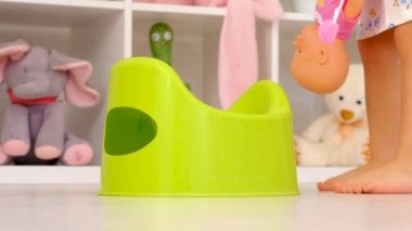 The child sits on the potty. Selective focus. Kid.