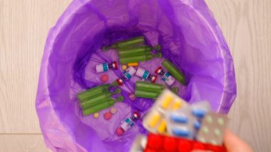 throws medicine pills into the trash. nature
