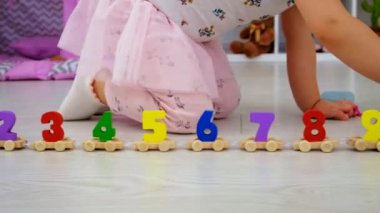 A child plays with a train made of numbers. Selective focus. Kid.