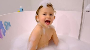 A child bathes in a bubble bath. Selective focus. Baby.