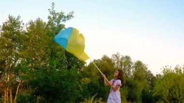 Üzerinde Ukrayna bayrağı olan nakışlı gömlekli bir çocuk. Seçici odaklanma. Doğa.