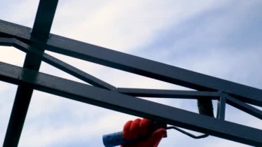 Bir adam silindirle metal boyuyor. Seçici odaklanma. İnsanlar.