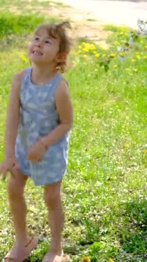 Child in a blooming garden in spring. Selective focus. Kid.
