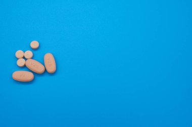 Opioid crisis drugs pills prescription medication light blue background blood pressure