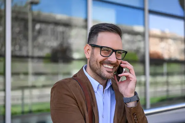 Male Manager Glasses Smiling Talking Mobile Phone While Standing Glass Стокове Фото
