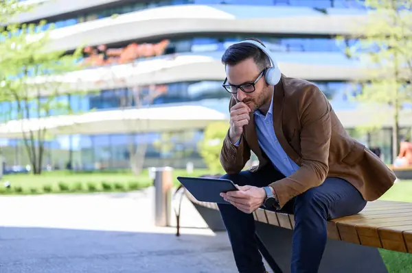 Focused Entrepreneur Hand Chin Listening Online Meeting Digital Tablet City Стокове Фото
