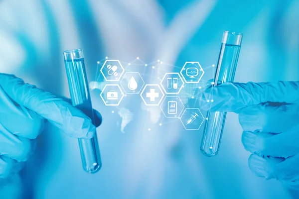 Healthcare and science technology. Scientist hand hold test tubes filled with blue sample chemicals in chemistry, biology, biotechnology laboratory. Innovation medicine, medical research. Glassware.