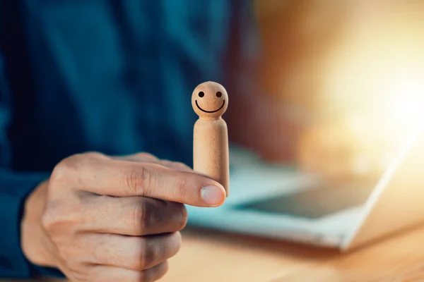 HR manager or Human resources. Employer hand choose takes person man wooden doll with smile face. Leader stands out from crowd. Looking for good worker. HR, HRM, HRD concepts.