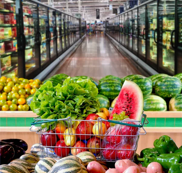 Supermarket basket with fruits, vegetables and leaves