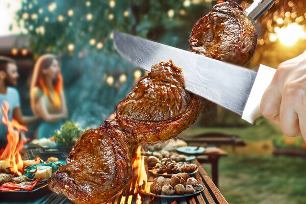 Barbecue with family and friends, Steak rotisserie at the steakhouse, sliced picanha