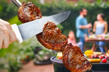 Steak rotisserie at the steakhouse, sliced picanha clipart