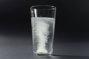 Siyah çelişkili arkaplanda kabarcıklar olan suda çözünür hap tableti şimdi düzenleme