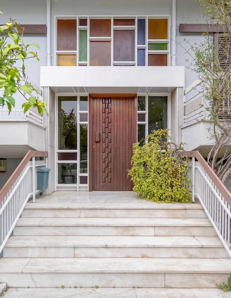 contemporary house entrance stairs and natural wood door, Athens Greece