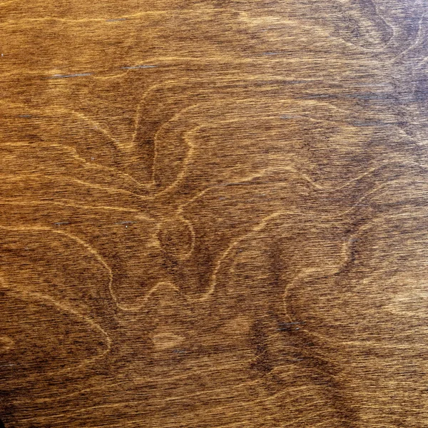 dark lacquered veined wood surface top view, brown background texture