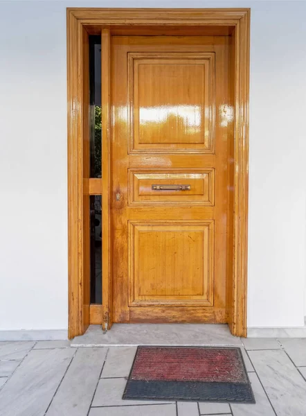 contemporary house entrance natural solid door on white washed wall, Athens Greece
