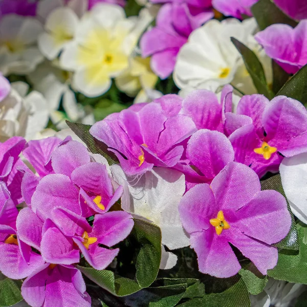 stock image violet and white colored artficial flowers bouquet close up, blurred background
