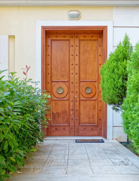 contemporary house classic design natural wood door and green foliage, Athens Greec