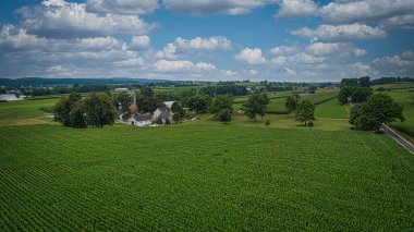 Drone View of Amish Countryside With Barns and Silos, a Patch Work of Corps and Farmlands on Sunny Day.