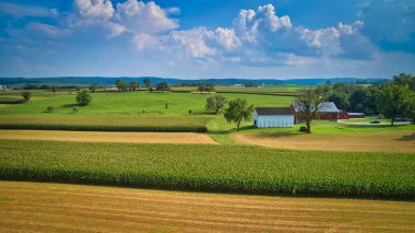 Drone View of Amish Countryside With Barns and Silos and Corn, Patch Work of Color and Corps, on Sunny Day.