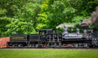 Cass, West Virginia, June 18, 2022 - A View of an Antique Shay Steam Engine Warming Up, Blowing Smoke and Steam on a Sunny Day