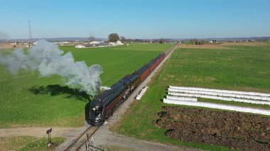 Ronks, Pennsylvania, November 9, 2022 - Drone View of a Steam Passenger Train Starting Up Blowing Black Smoke on a Fall Day