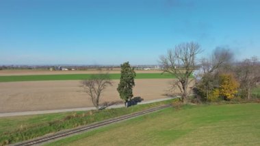 Ronks, Pennsylvania, November 9, 2022 - Drone In Front of View of a Steam Passenger Train Blowing Lots of Smoke and Steam on a Sunny Fall Day