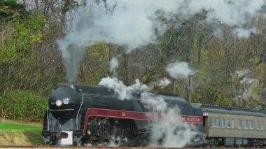 Ronks, Pennsylvania, November 13, 2022 - A View of a Steam Passenger Train Stopped on a Cold Fall Day With Lots of Smoke and Steam