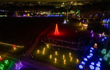 An Aerial View of a Large Christmas Drive Thru Display, with Multi Colored Lights, Seen at Night