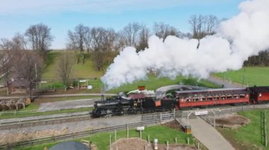 Ronks, Pennsylvania, December 4, 2022 - An Aerial View of a Steam Passenger Train Slowly Traveling Thru an Amusement Park, in the Pennsylvania Dutch Country